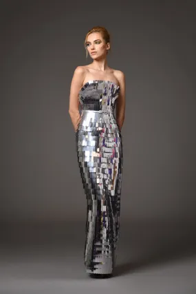 A futuristic dress crafted from layers of intricately laser-cut silver mirror pvc