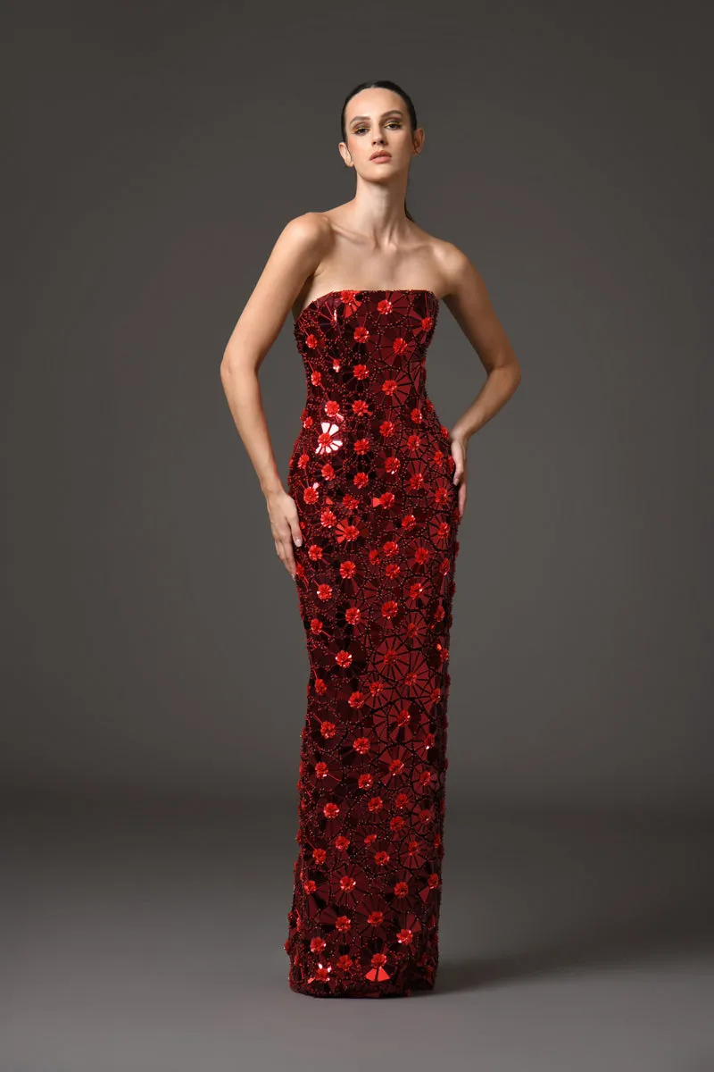 A futuristic red dress adorned with intricate floral patterns embroidered with mirror plexiglass, featuring detachable silk taffeta sleeves/cape